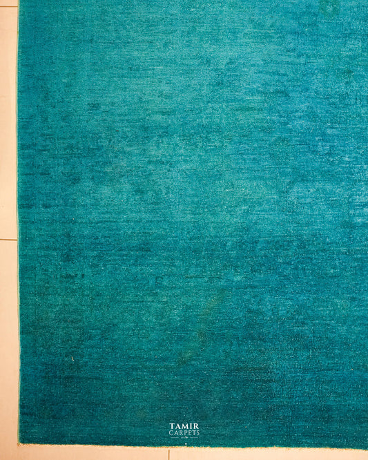 Turquoise overdyed field of the Chobi rug with faint original pattern