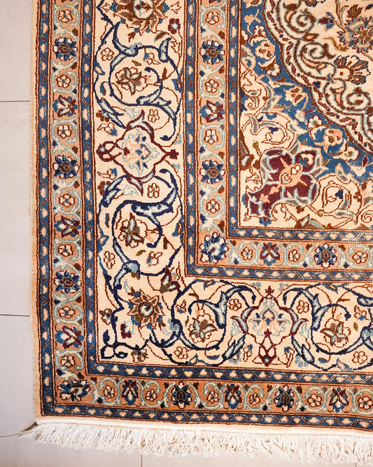 Corner of the Ispahan rug showing its layered blue and ivory borders