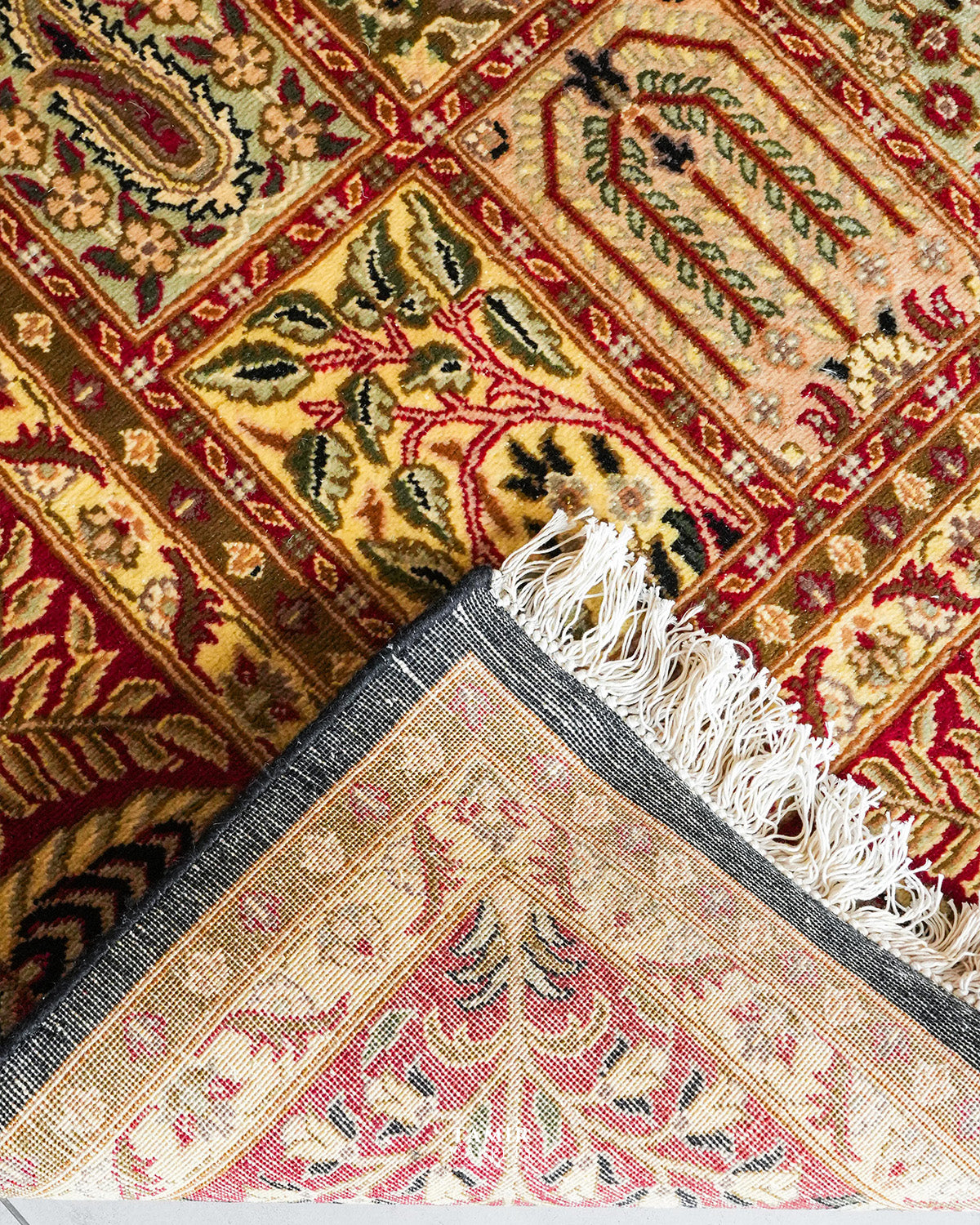Folded corner showing the back weave of the double-knotted Bakhtiari Black rug