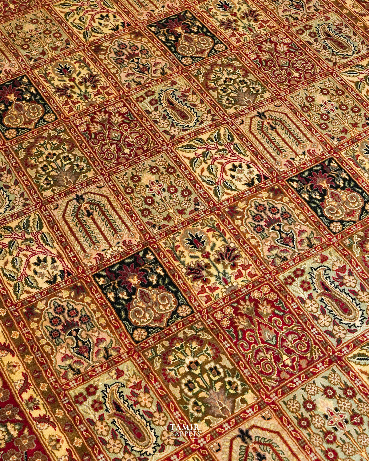 Angled close view of the garden panels on the Bakhtiari Black New Zealand wool rug