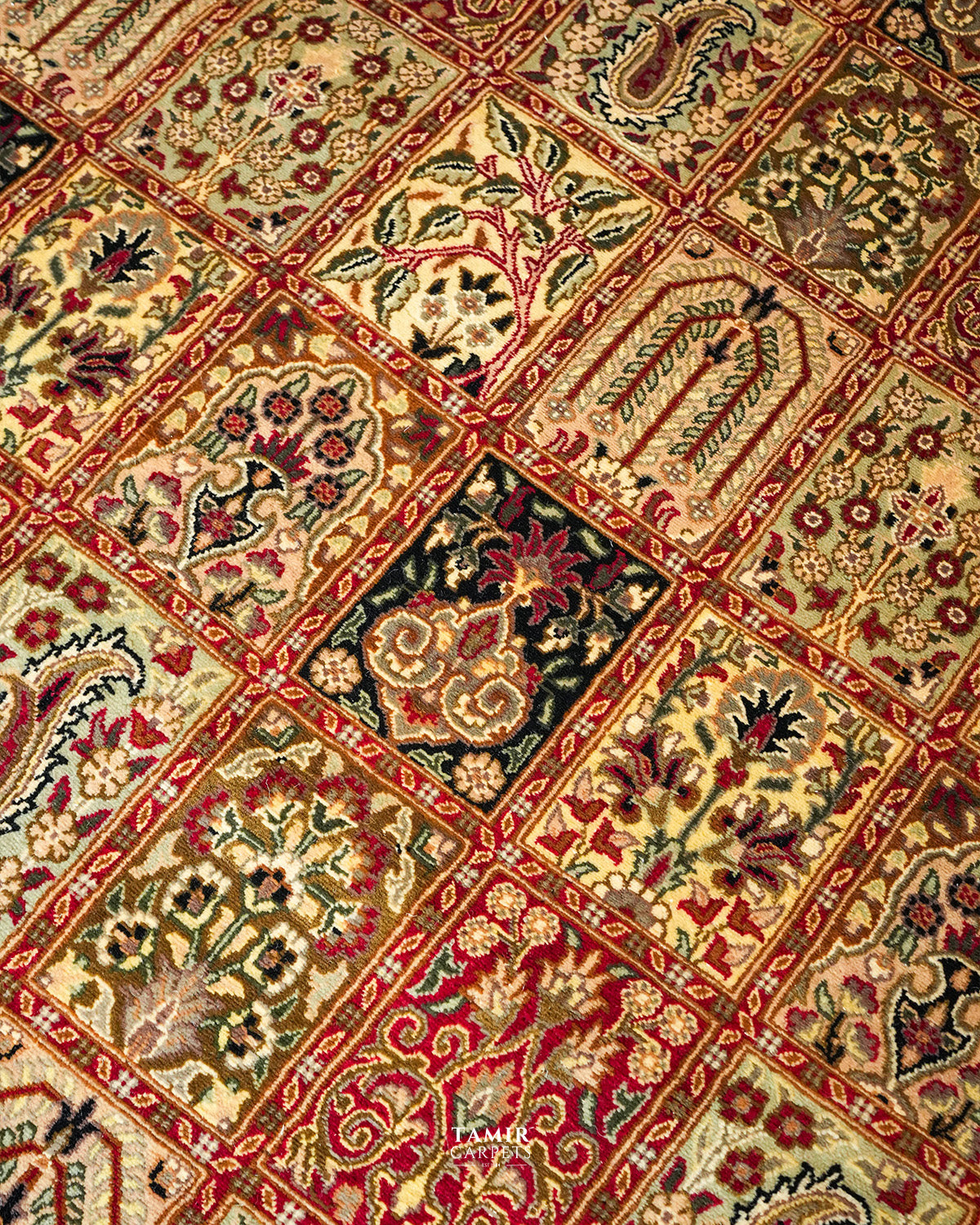 Detail of floral and tree motifs in the Bakhtiari Black Persian rug