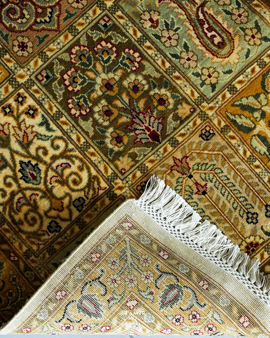 Folded corner showing the back weave and fringe of the 256 KPSI Bakhtiari Runner