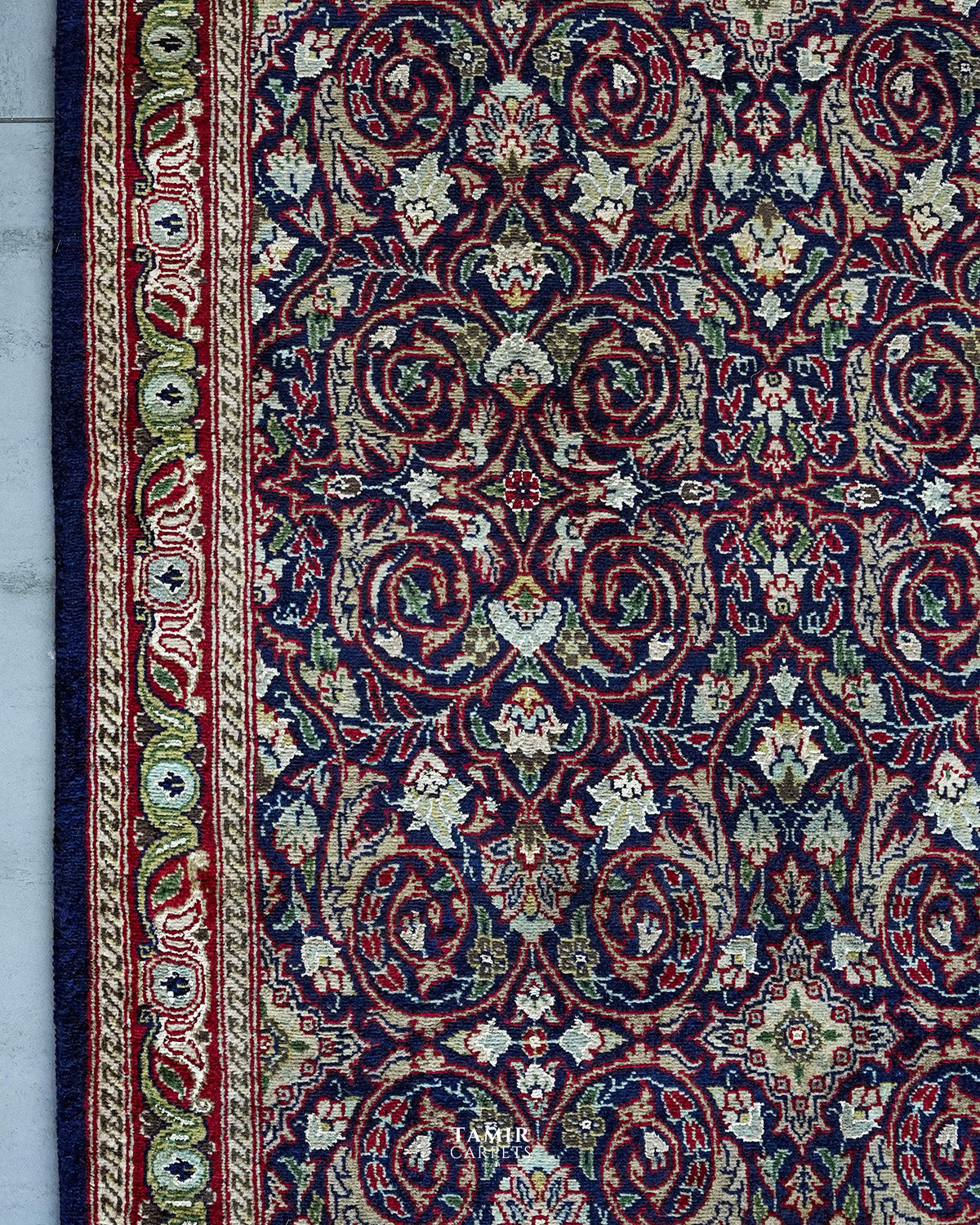 Detail of the floral border and navy field in organic-dyed wool