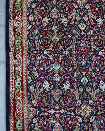 Detail of the floral border and navy field in organic-dyed wool