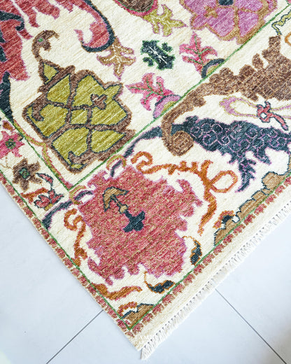 Close-up of Bidjaar rug floral palmette in rose pink and sage green