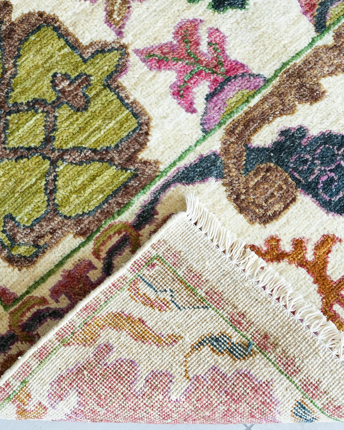Detail of Bidjaar rug scrolling vine pattern on ivory organic wool