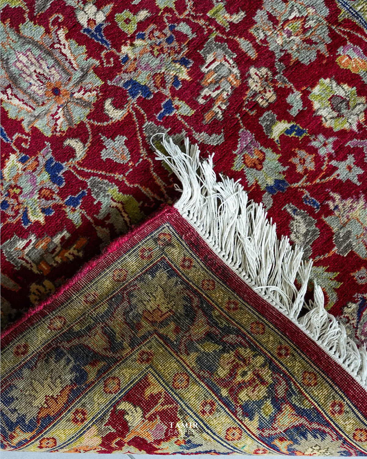 Folded corner showing the back weave and fringe of the double-knotted Chobi rug