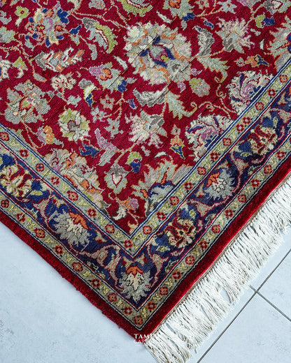 Blue floral border and white fringe on the handmade Chobi rug