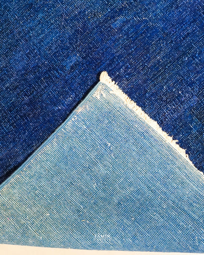 Folded corner showing the back weave of the double-knotted overdyed rug