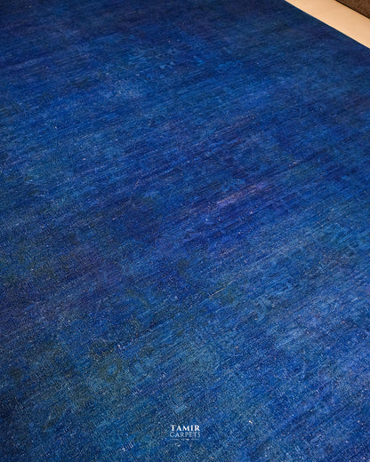 Royal blue overdyed field with faint traces of the original Chobi pattern