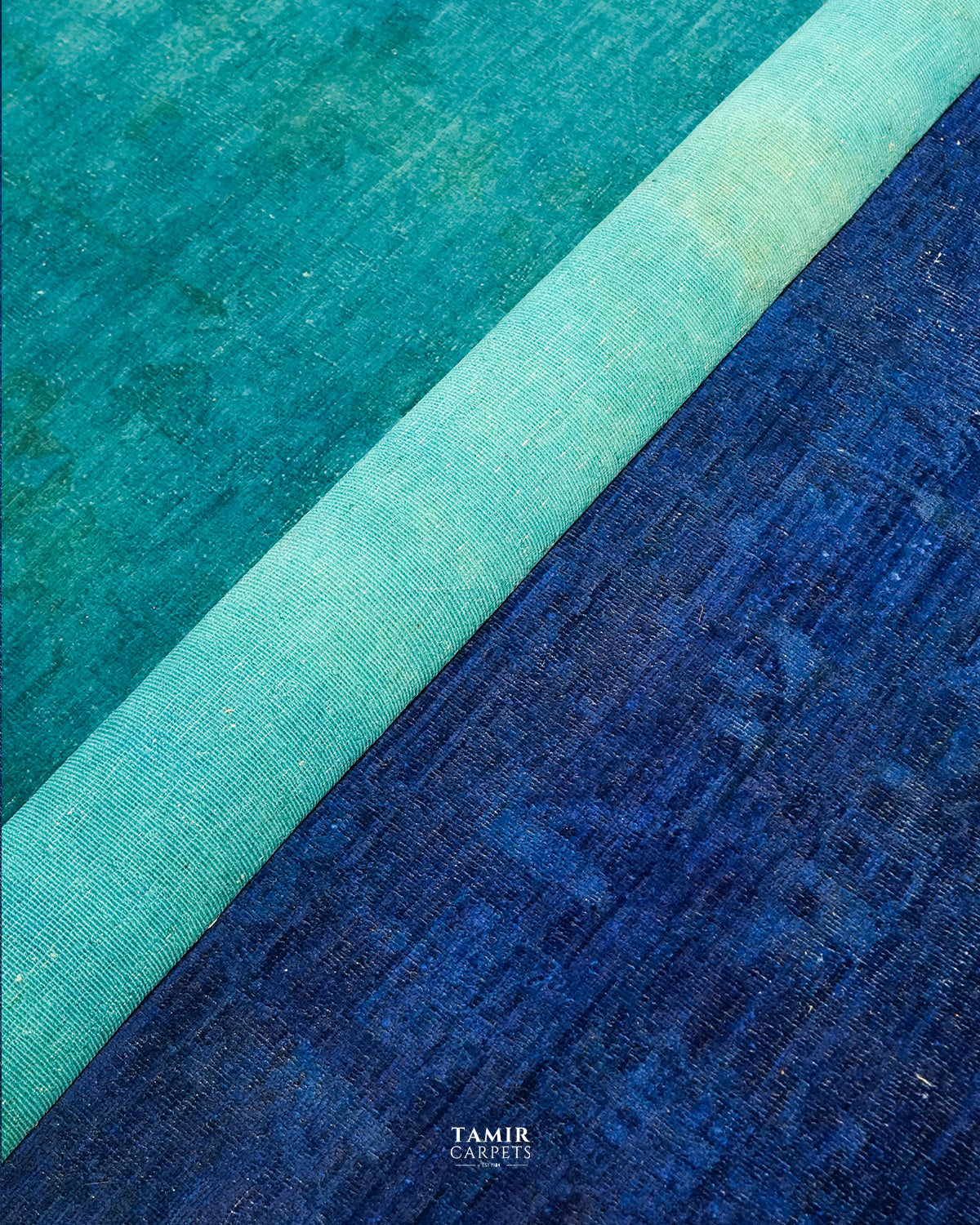 Rolled edge of the 10x14 Chobi Overdyed rug showing the pile