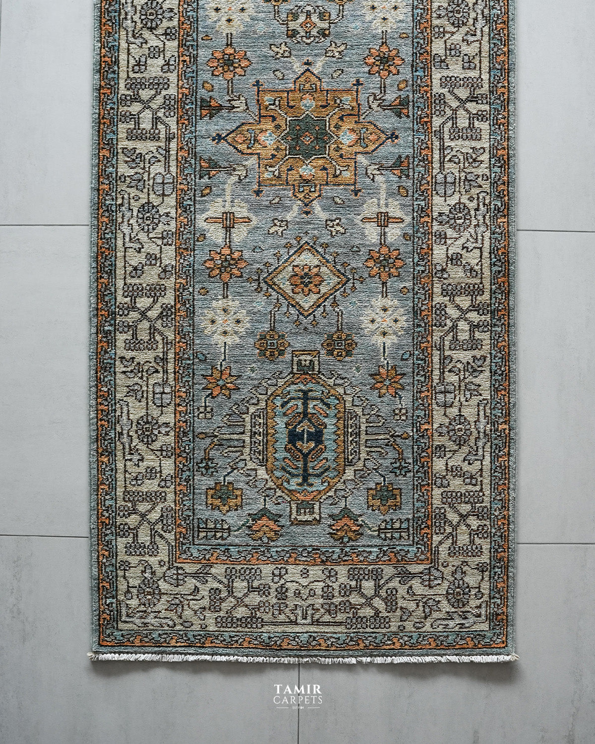Top section of the Chobi Runner showing medallions and the ivory border