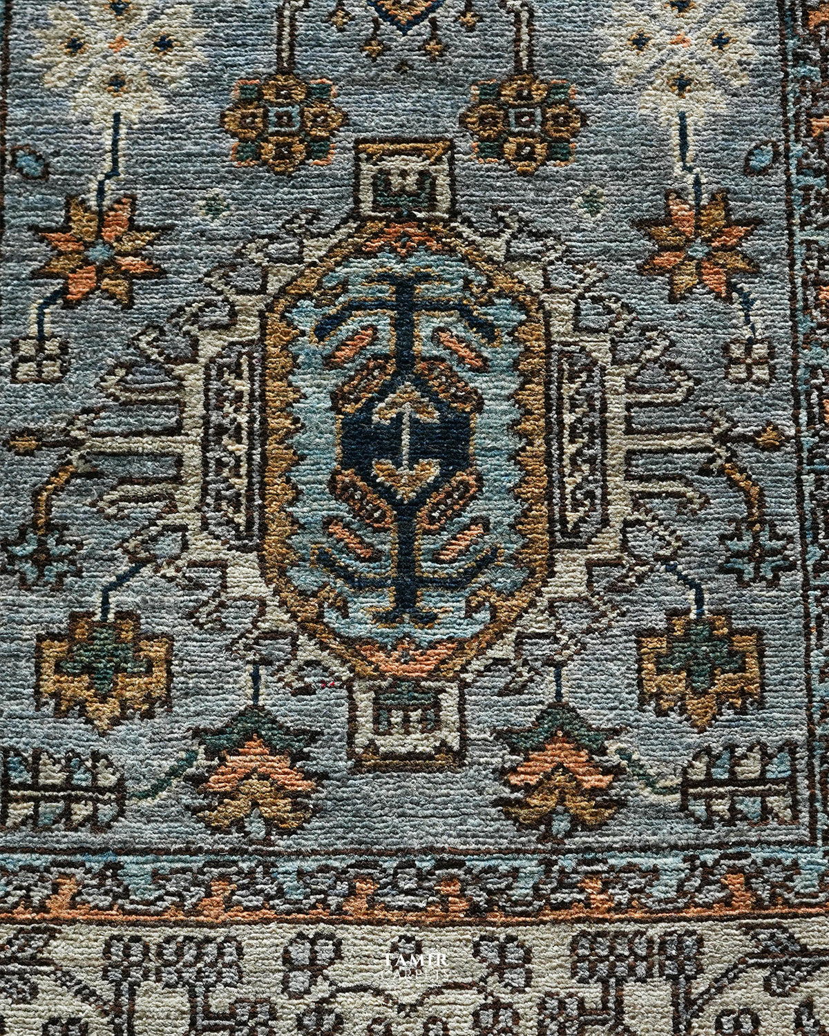 Close view of the rust and navy medallion on the grey Chobi Runner