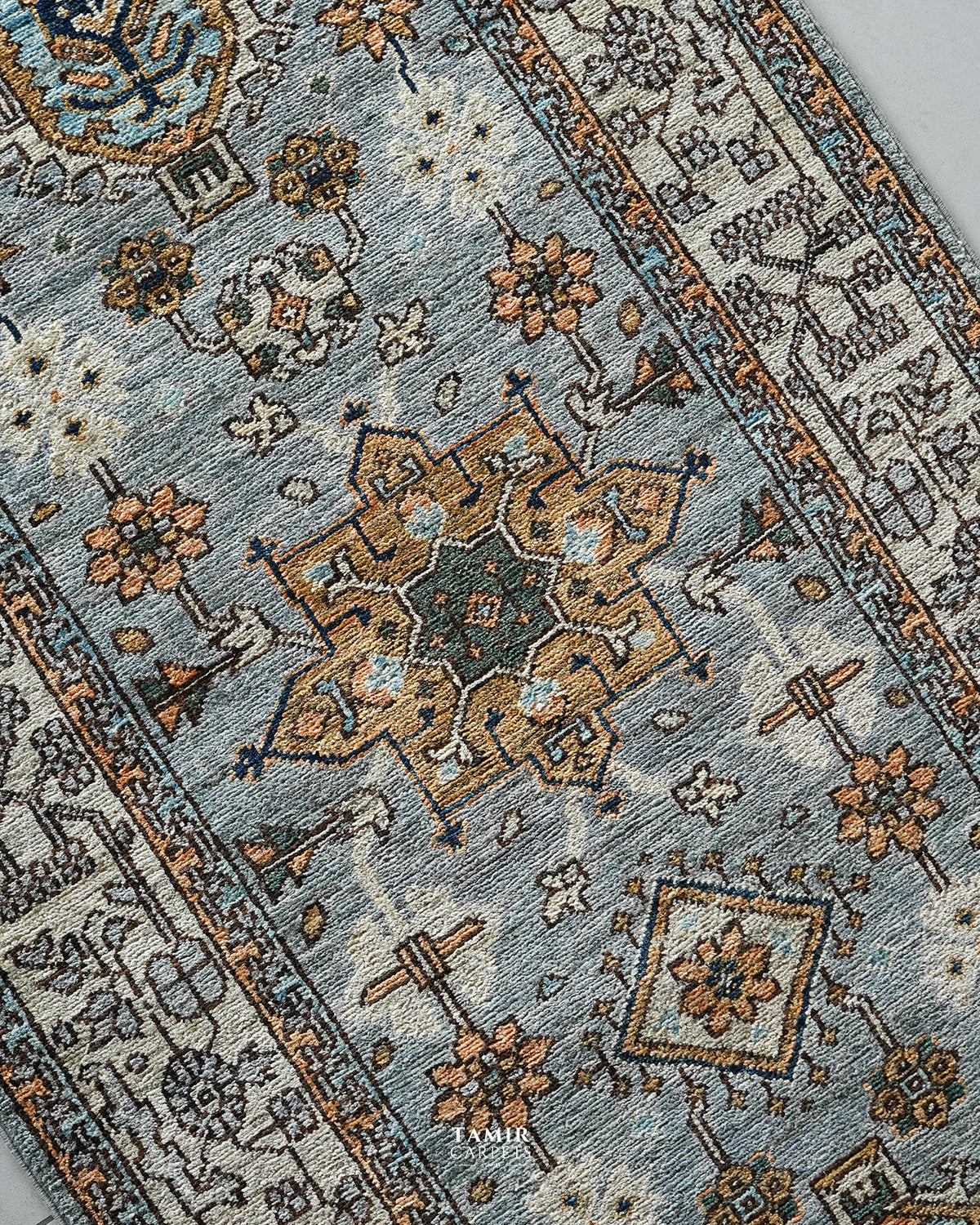 Angled view of the Afghan floral motifs on the 2.5x10 Chobi Runner