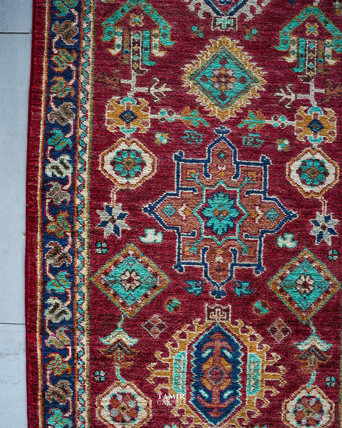 Turquoise and gold medallions on the red Chobi Runner