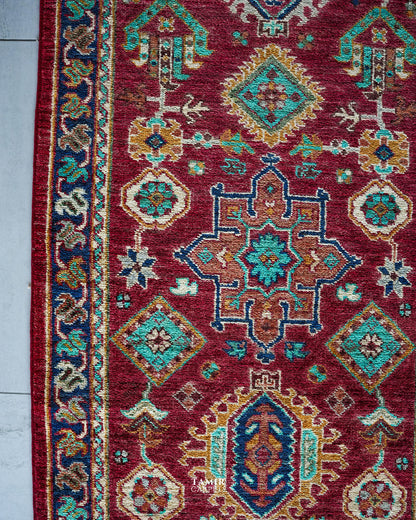 Turquoise and gold medallions on the red Chobi Runner