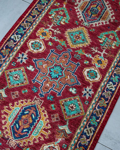 Angled view of the tribal medallions on the single-knotted Chobi Runner