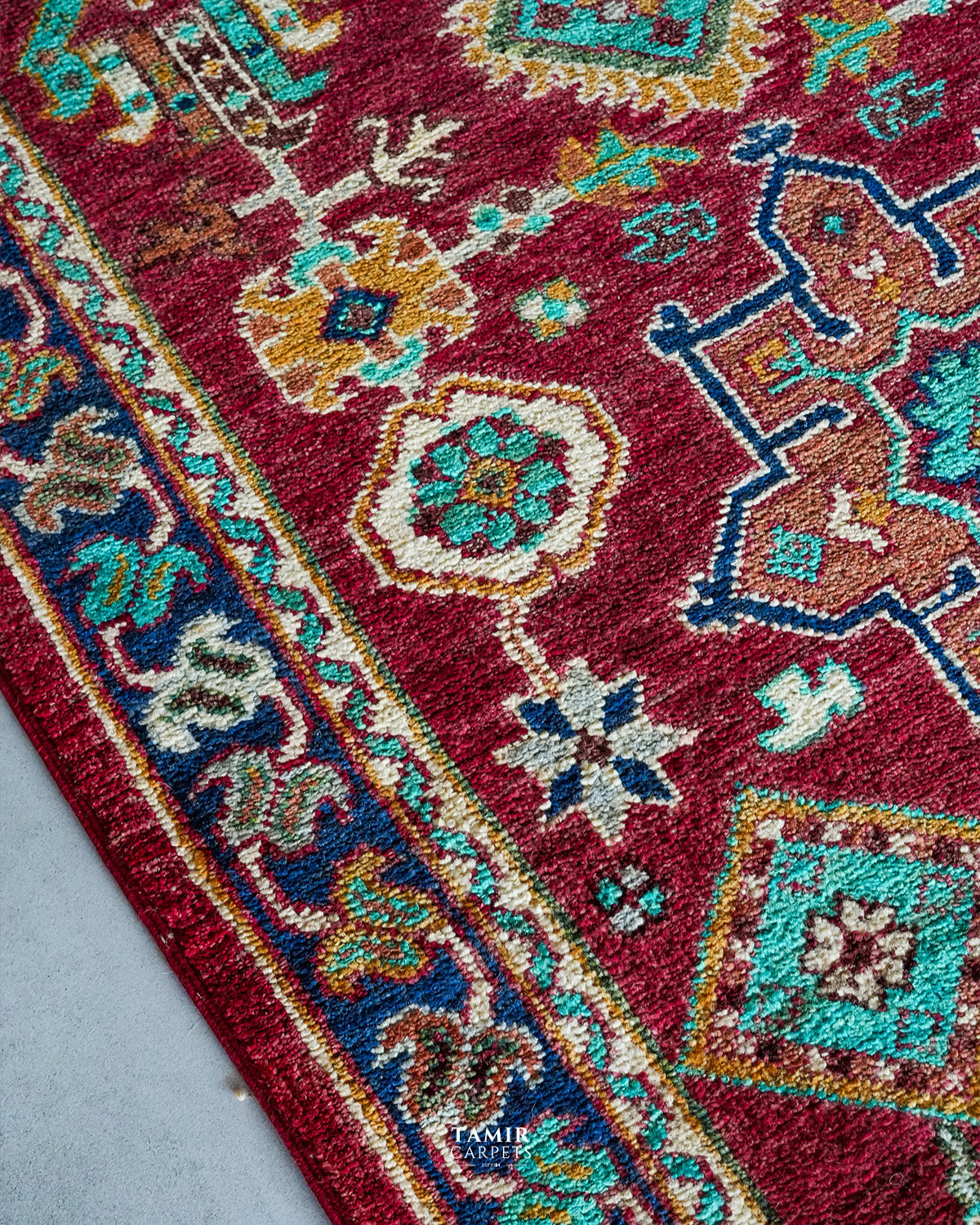 Navy border and medallion detail in organic-dyed handspun wool