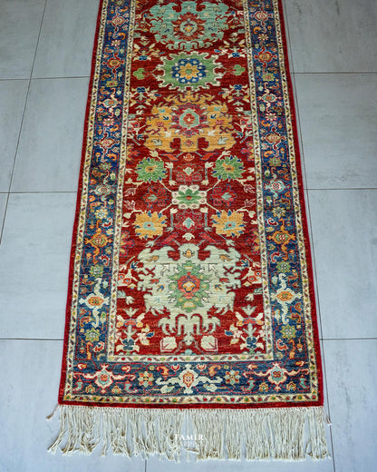End section of the Chobi Runner with blue border and long fringe
