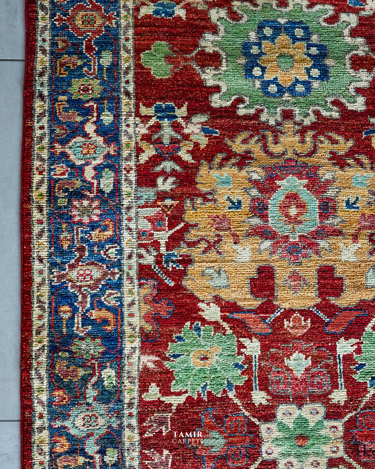 Green, gold and cream floral motifs on the red Chobi Runner