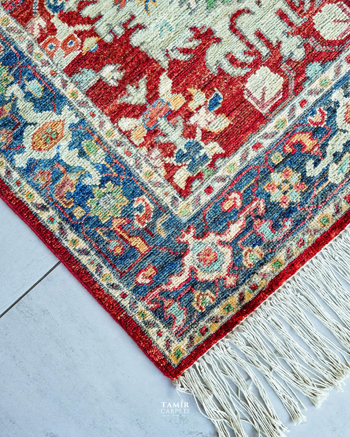 Corner of the 3x10 runner showing the blue floral border and fringe