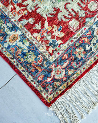 Corner of the 3x10 runner showing the blue floral border and fringe