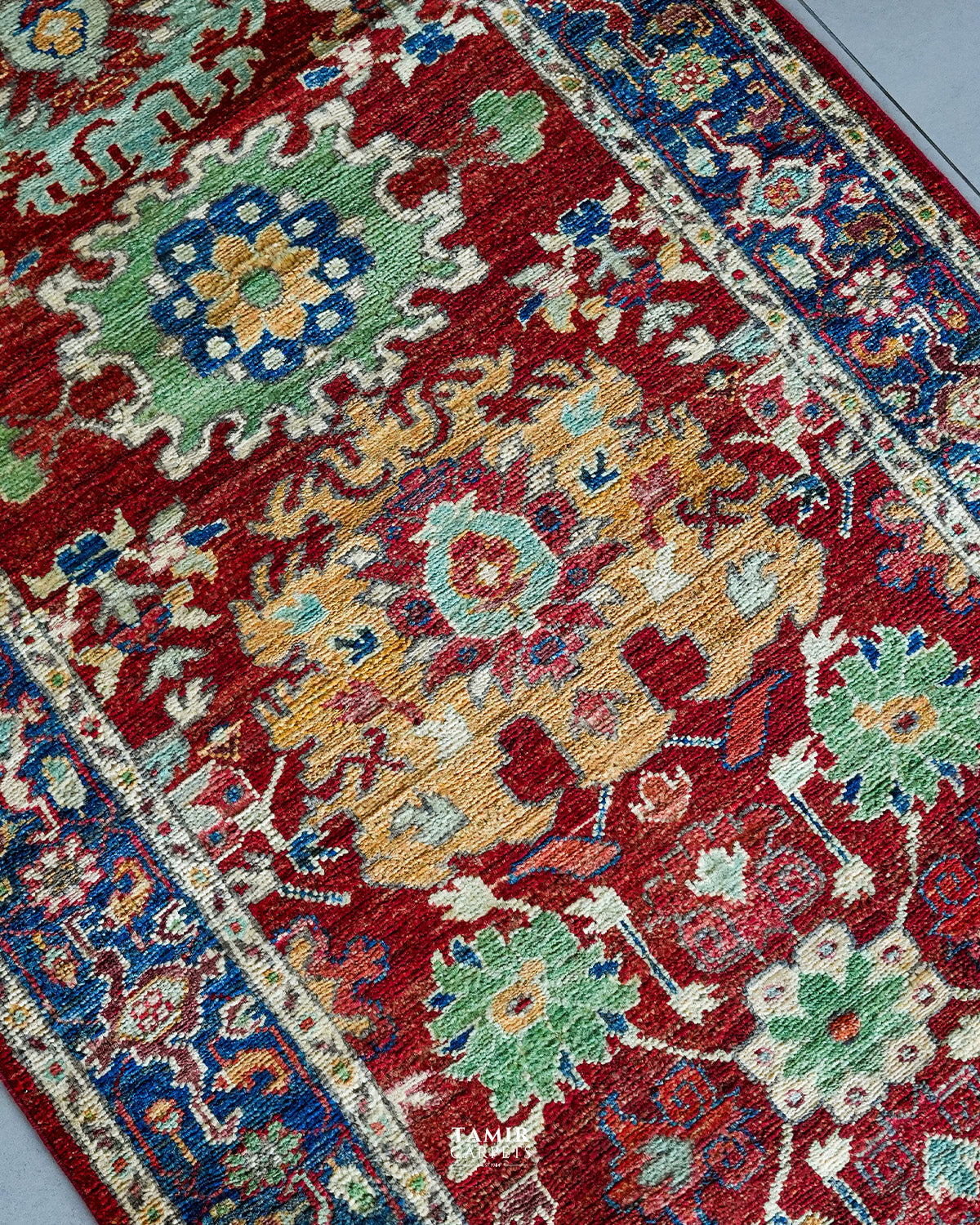 Angled close-up of floral motifs in organic-dyed handspun wool
