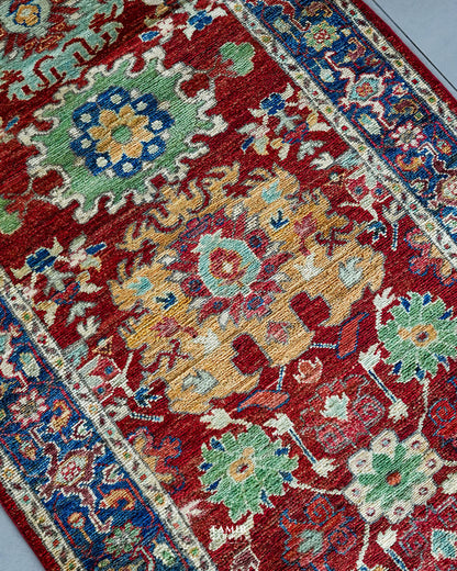 Angled close-up of floral motifs in organic-dyed handspun wool