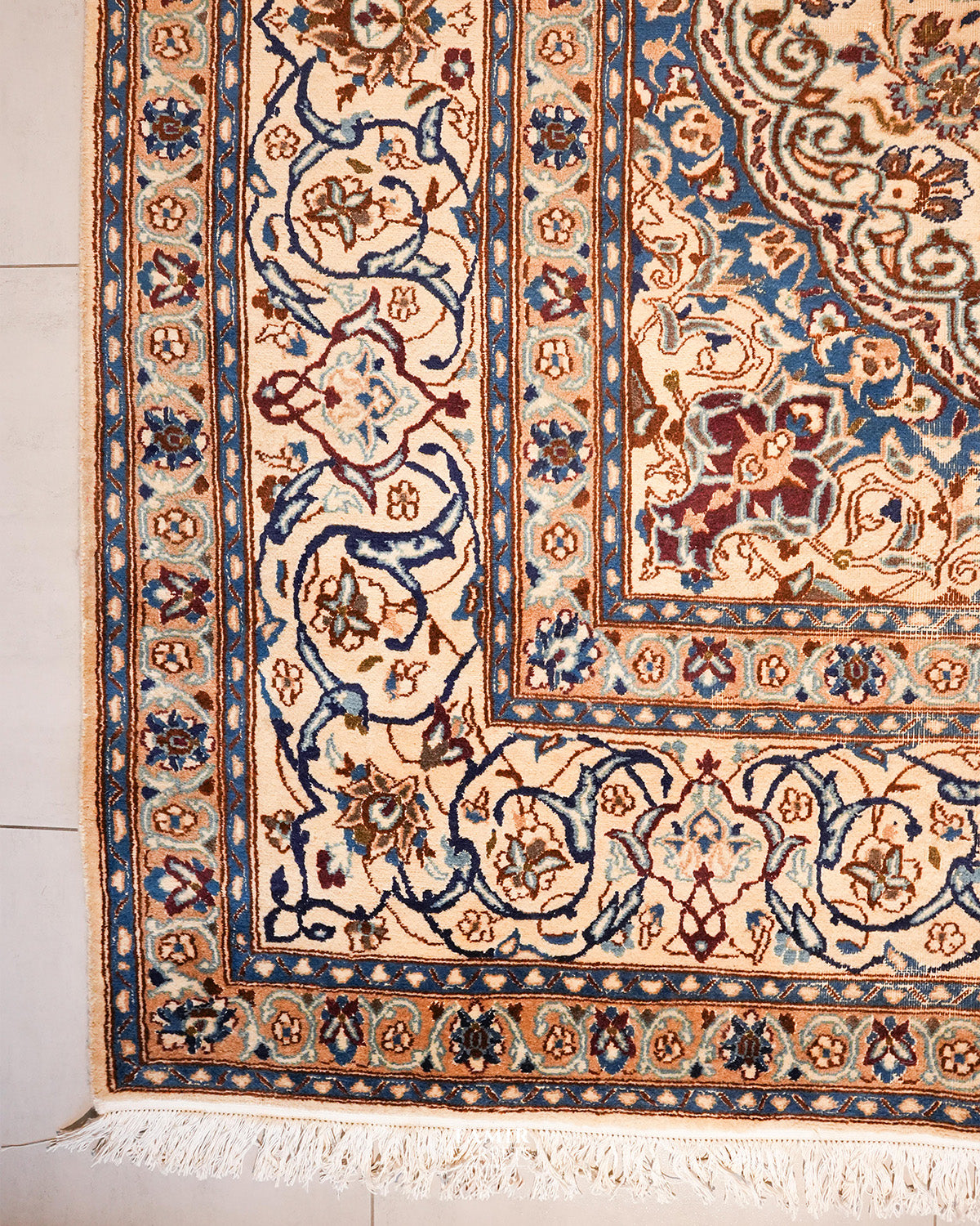 Corner of the Ispahan rug showing its layered blue and ivory borders