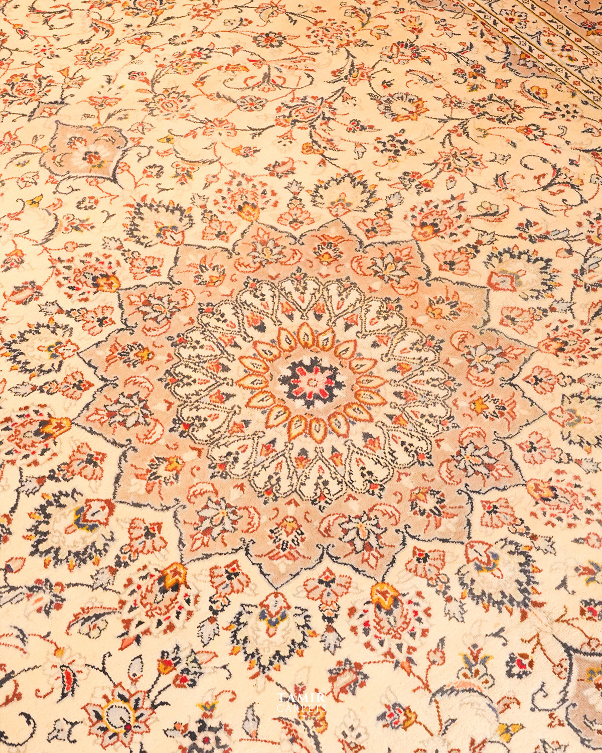 Close view of the medallion and floral scrolls on the ivory field