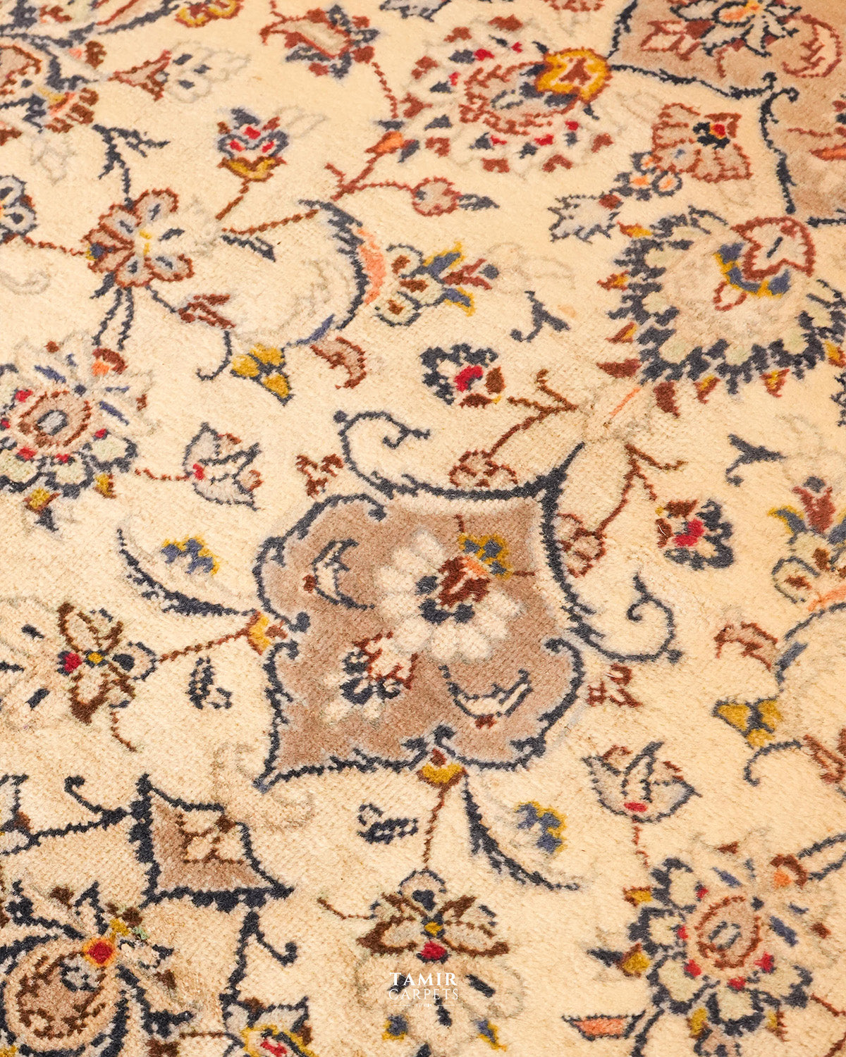 Detail of navy, gold and red floral motifs in organic-dyed wool