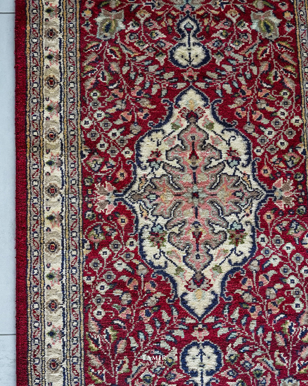 Ivory central medallion on the red field of the Kashaan Runner