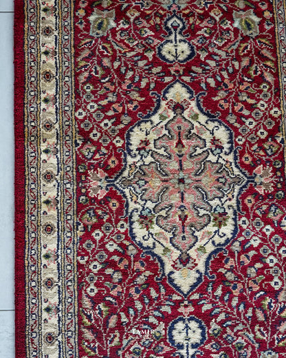 Ivory central medallion on the red field of the Kashaan Runner