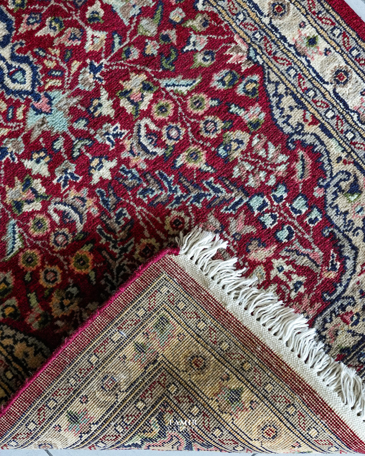 Folded corner showing the back weave of the single-knotted Kashaan Runner