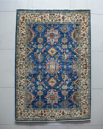 Top view of the Kazaak rug's blue field with red and aqua medallions