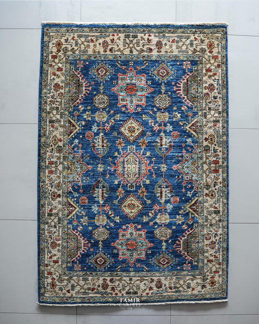 Top view of the Kazaak rug's blue field with red and aqua medallions