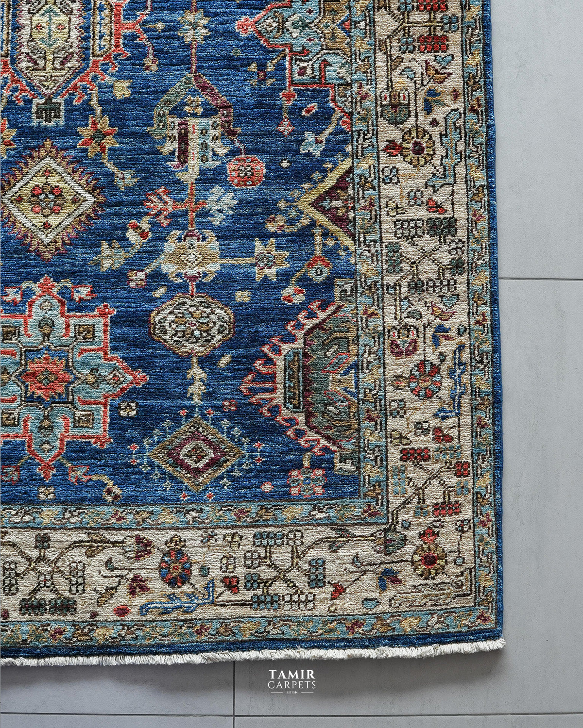 Corner of the Kazaak 4x6 rug showing the ivory geometric border
