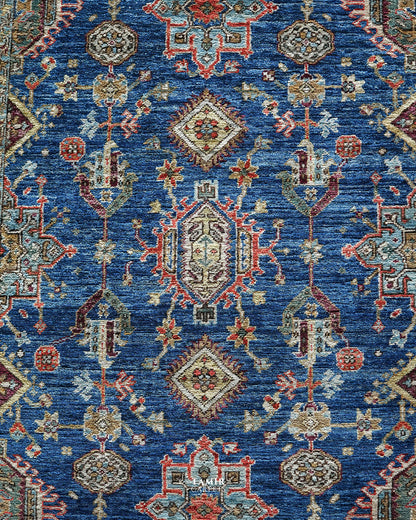 Detail of the red, gold and aqua motifs on the blue Kazaak rug