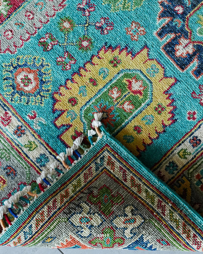 Folded corner showing the back weave of the double-knotted Khurjeen rug