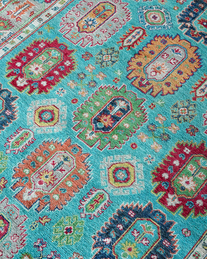 Red, orange and navy medallions on the turquoise Khurjeen field