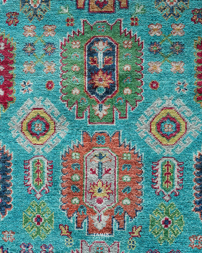 Detail of green and red medallions on the blue Khurjeen Afghan rug