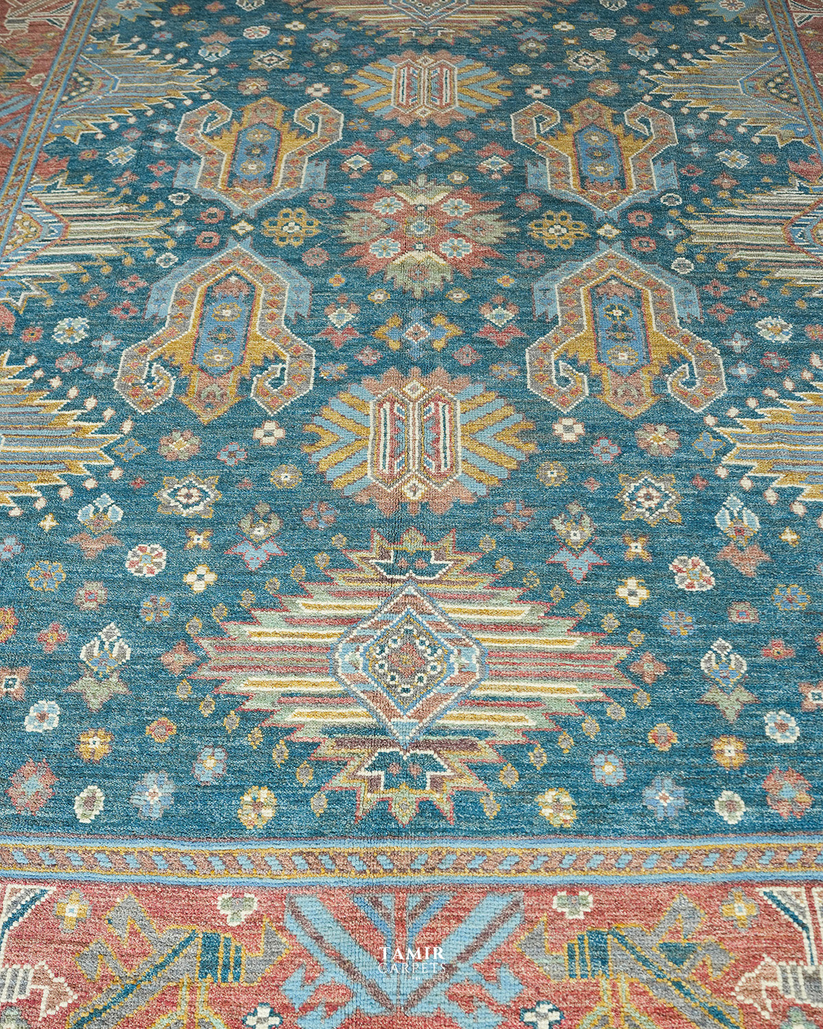 Gold and cream geometric medallions on the teal Oushak field