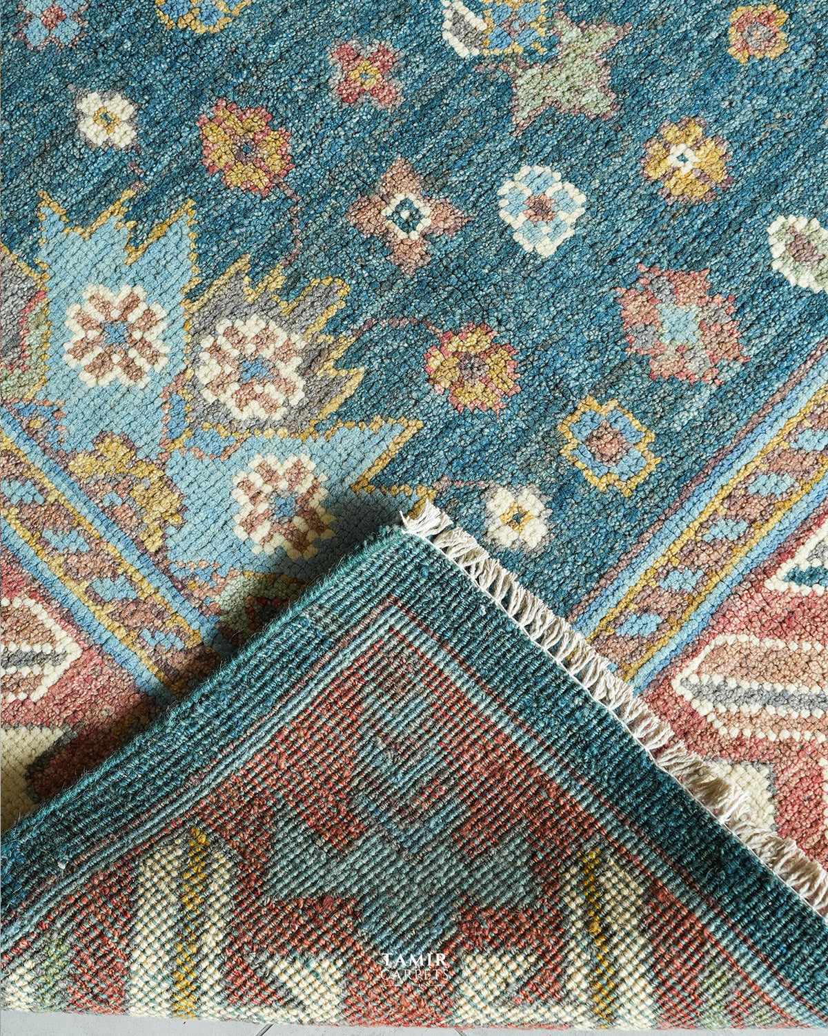 Folded corner showing the back weave of the double-knotted Oushak rug