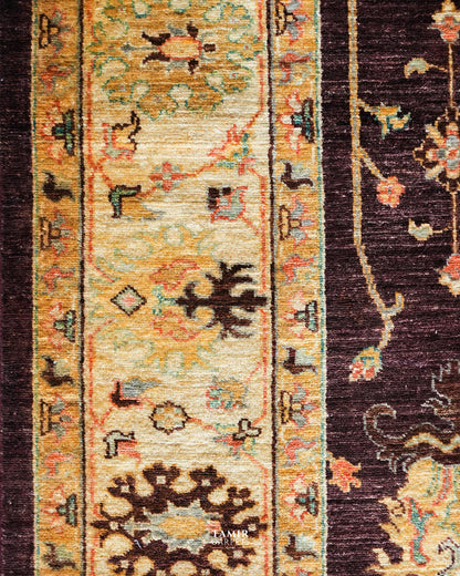 Detail of the gold and cream floral border on the Oushak rug