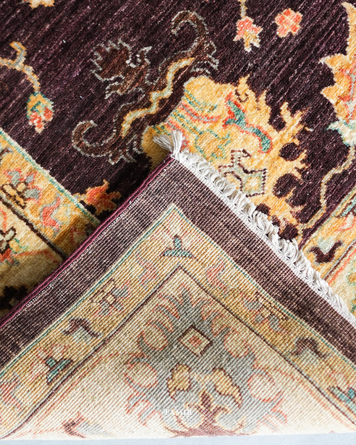 Folded corner showing the back weave of the double-knotted Oushak rug