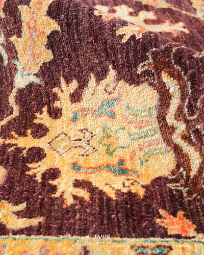 Close-up of a gold palmette on the chocolate-brown Oushak field