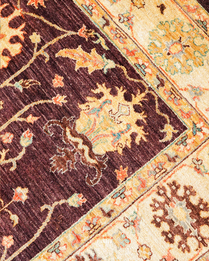 Brown field meeting the golden border on the handmade Oushak rug
