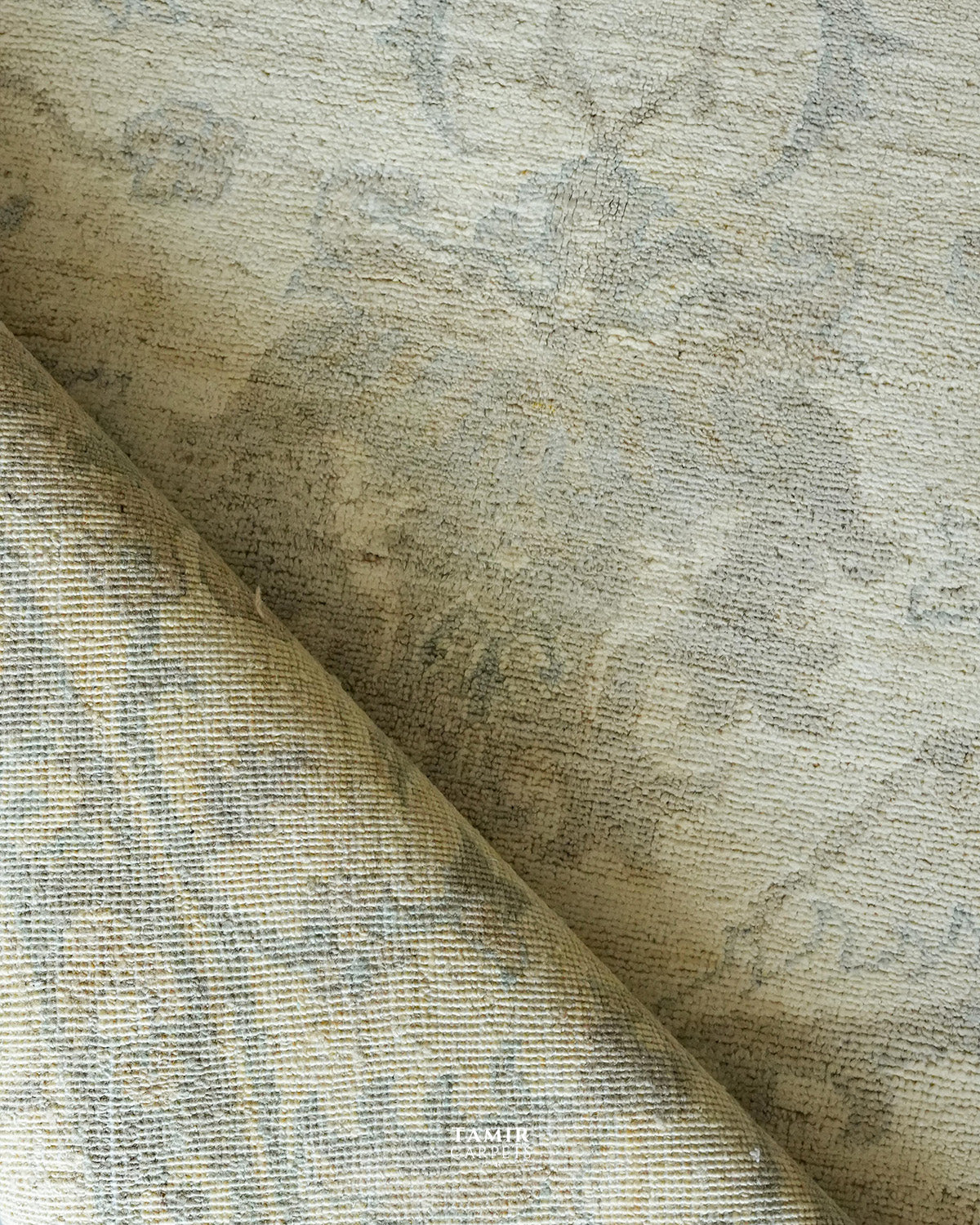 Folded section of the Round Oushak rug showing pile and backing