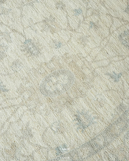 Close-up of pale blue and sand floral motifs in organic handspun wool