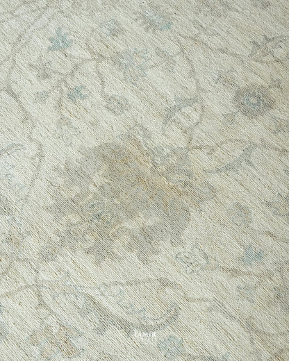 Detail of the ivory Oushak field and floral vines on the round rug